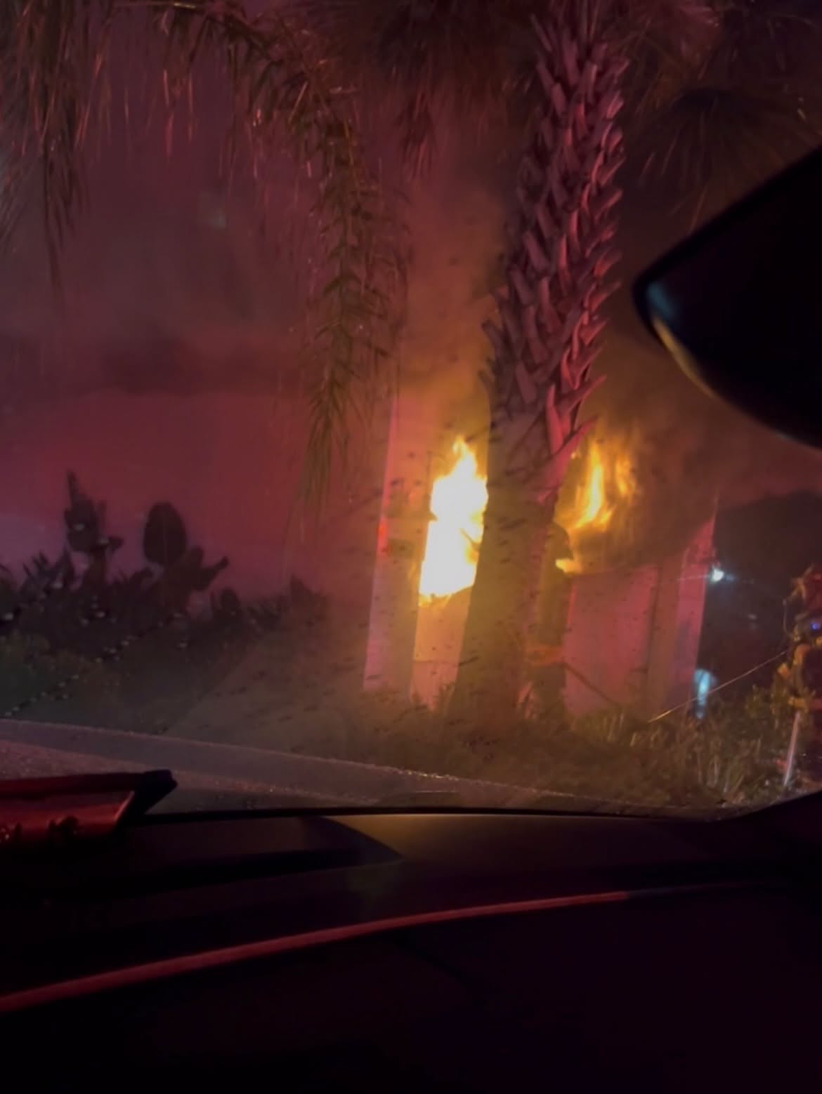 Fire visible inside a Beachwalk home's attached garage at night.
