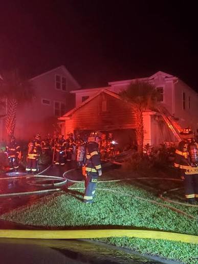 Firefighters gathered at the garage during the emergency response.